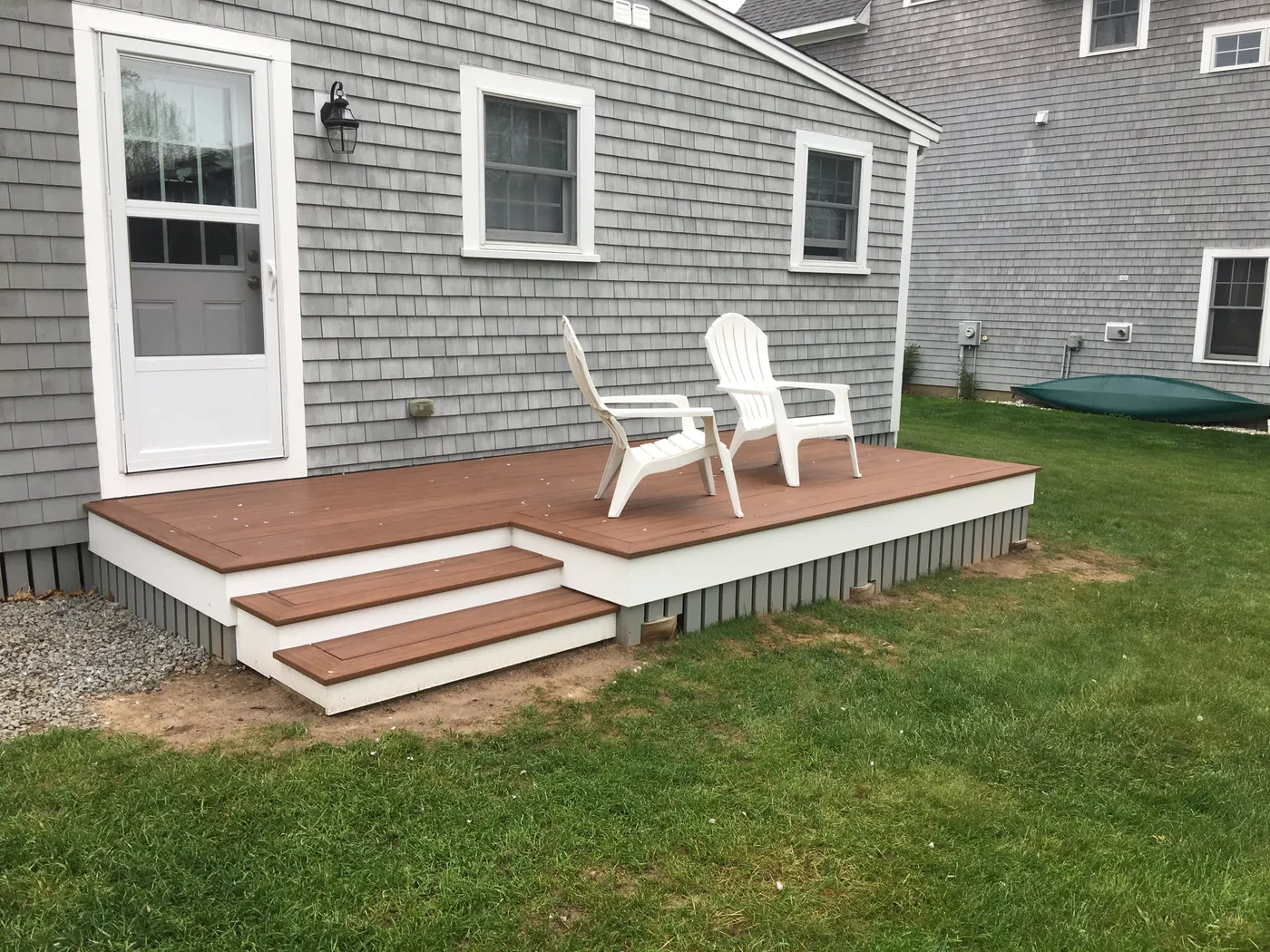 New composite deck and steps on a shingled home