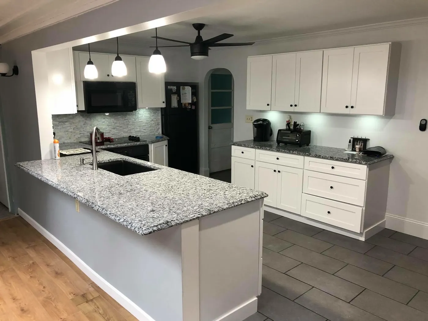 Remodeled kitchen with granite peninsula