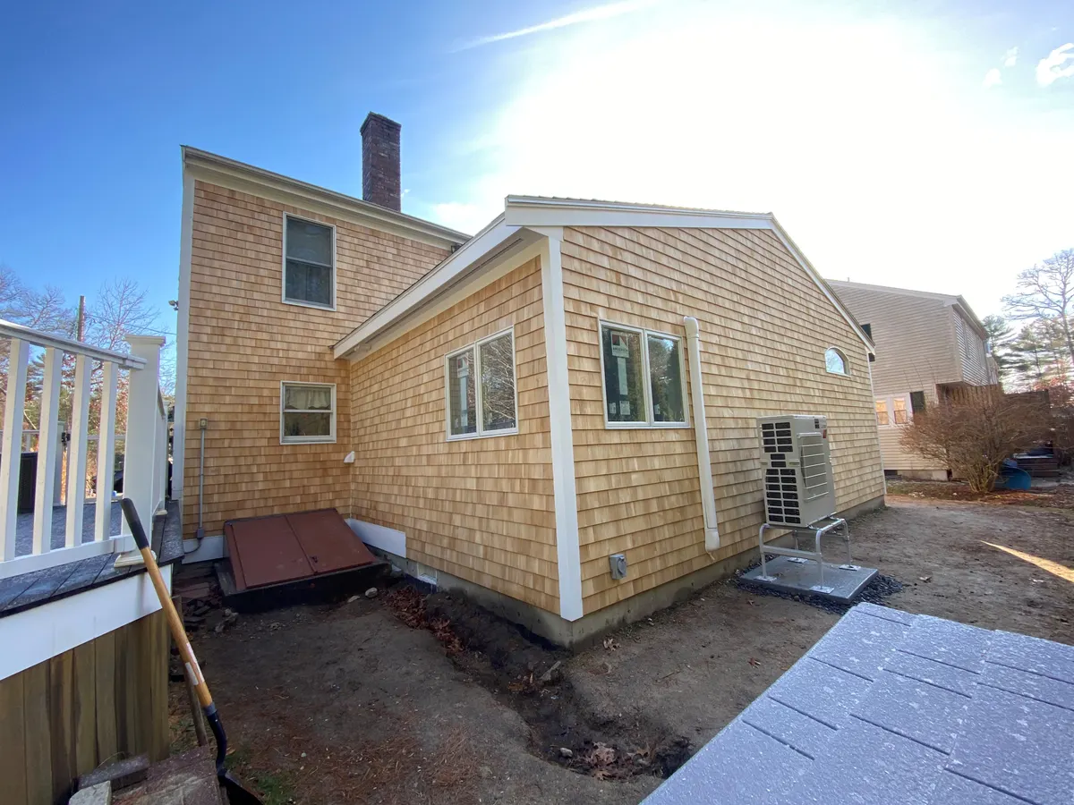 Cedar-shingled addition by Demers Construction Company
