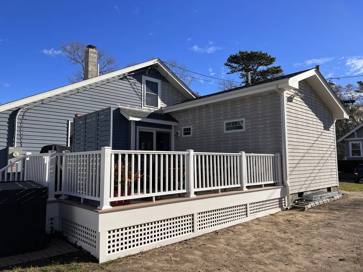 Porch and railing addition on a gray home
